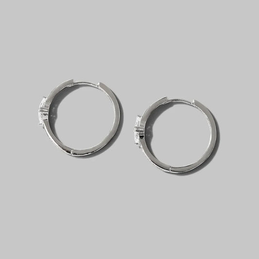Pair of inlaid zircon 925 sterling silver hoop earrings on gray background