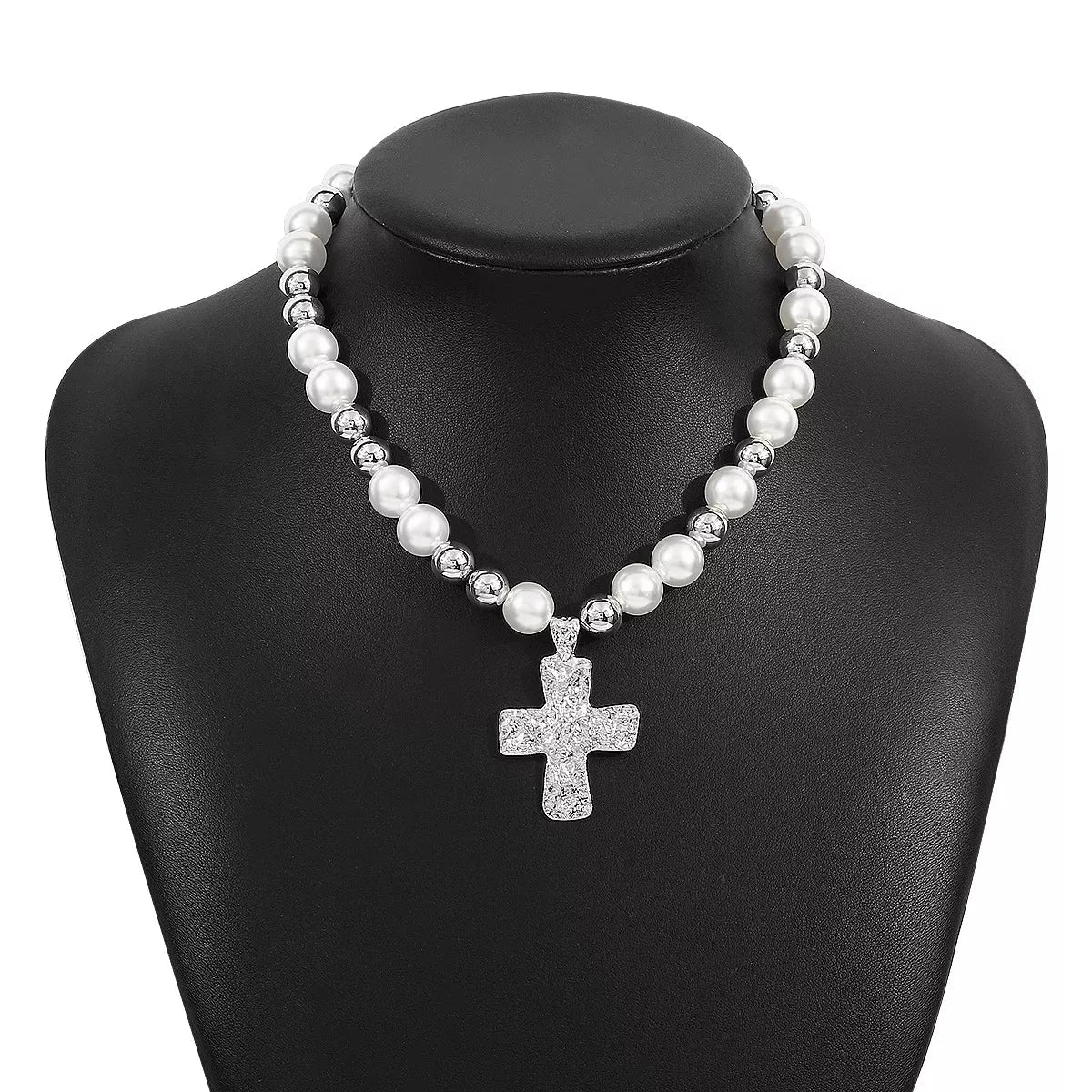 Pearl and cross pendant necklace with synthetic pearls and 18K gold-plated chain on black display bust