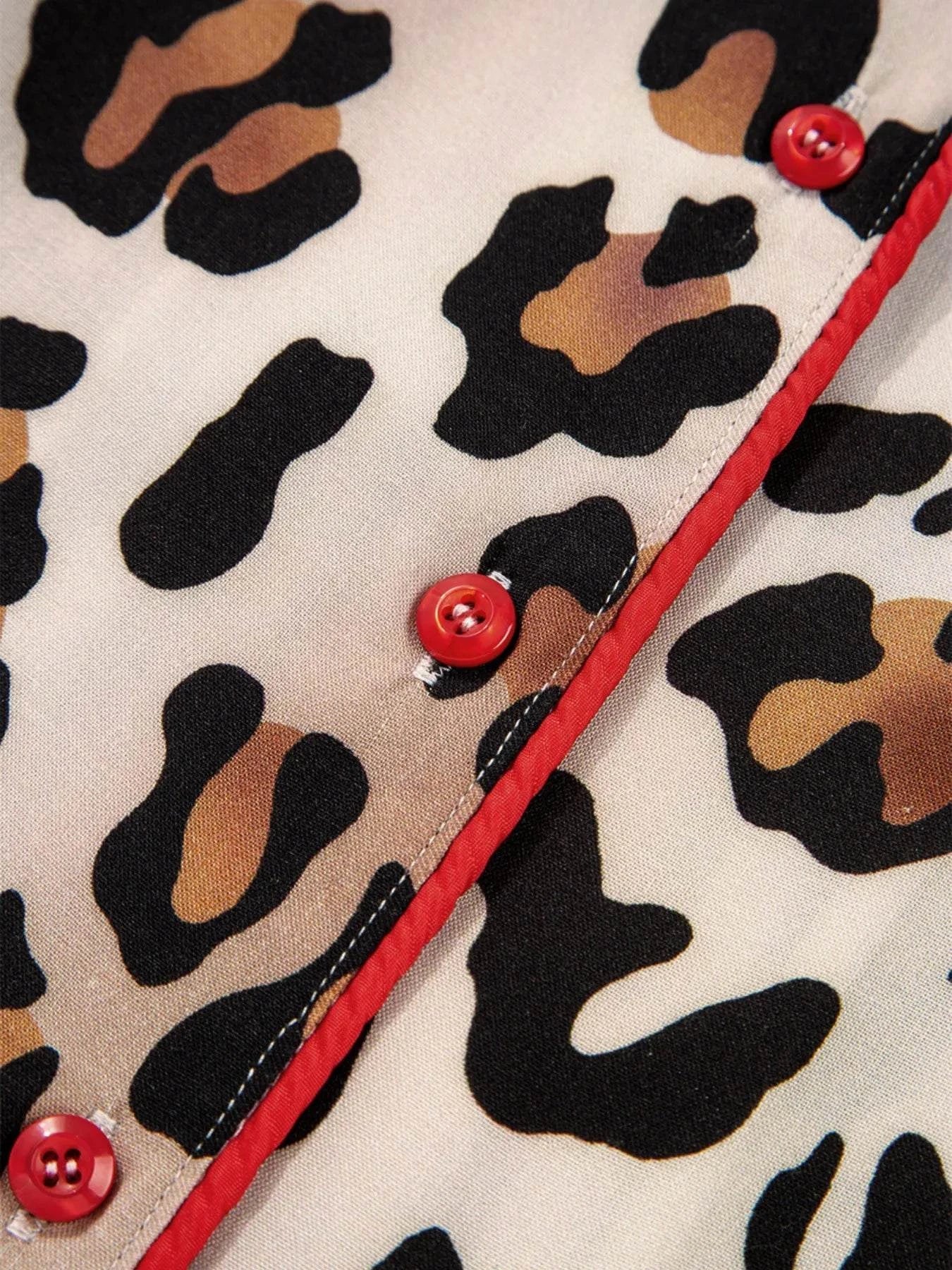 Close-up of leopard print fabric with red striped trim and buttons on leopard and striped trim shirt