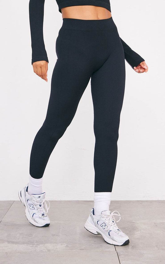 Black structured contour ribbed leggings styled with athletic shoes and long sleeve top.