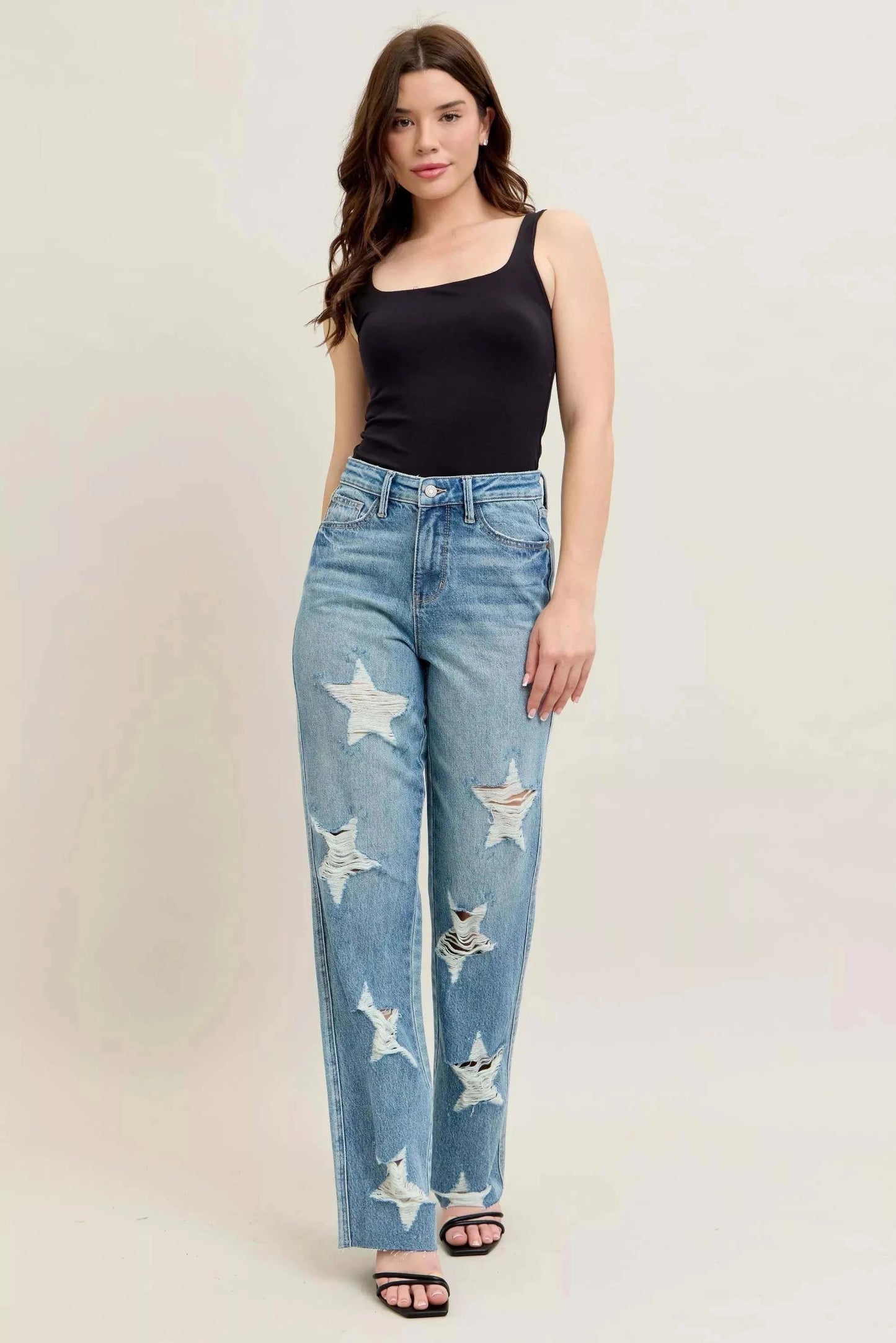 Judy Blue Plus Size 90's high waist straight jeans with star-shaped distressed details worn by woman in black tank top