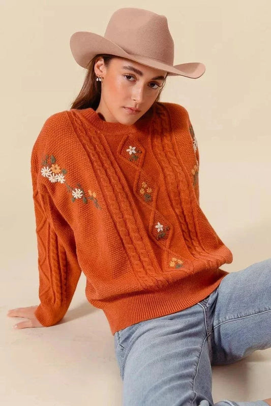 SO ME Embroidered Flower Cable Knitted SweaterElevate your winter wardrobe with this charming embroidered flower cable knitted sweater. The intricate floral embroidery adds a delicate and feminine touch to the cRedemption By Ashley NorthEmbroidered Flower Cable