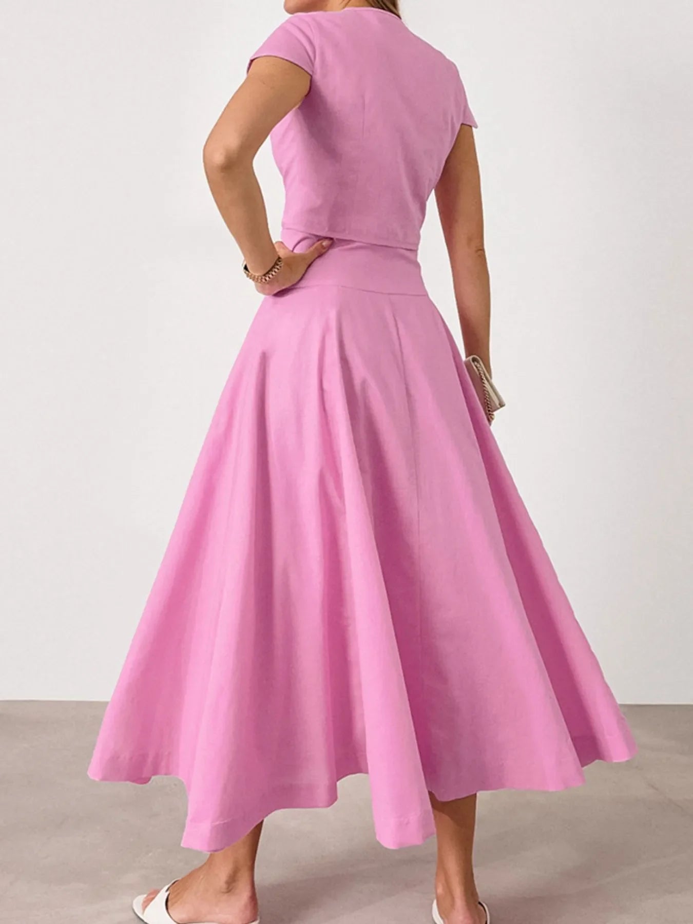 Woman wearing pink two-piece short sleeve top and skirt set made of 100% cotton