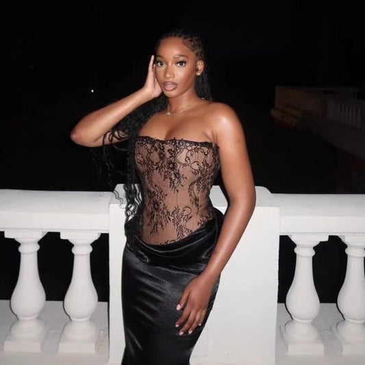 woman wearing black sexy bandage tube top skirt outfit standing outdoors at night