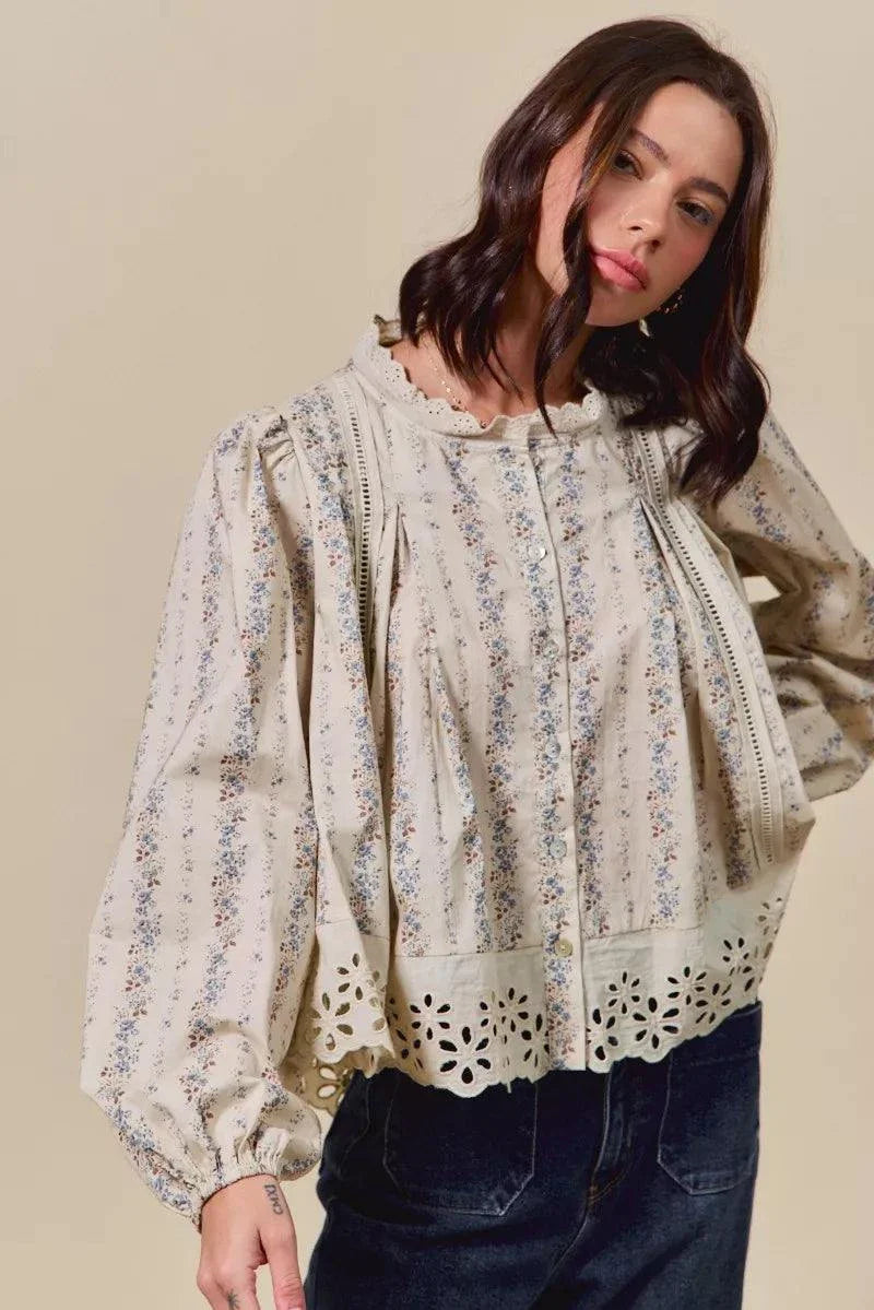 woman wearing floral print lace button-down shirt with eyelet and ruffled details