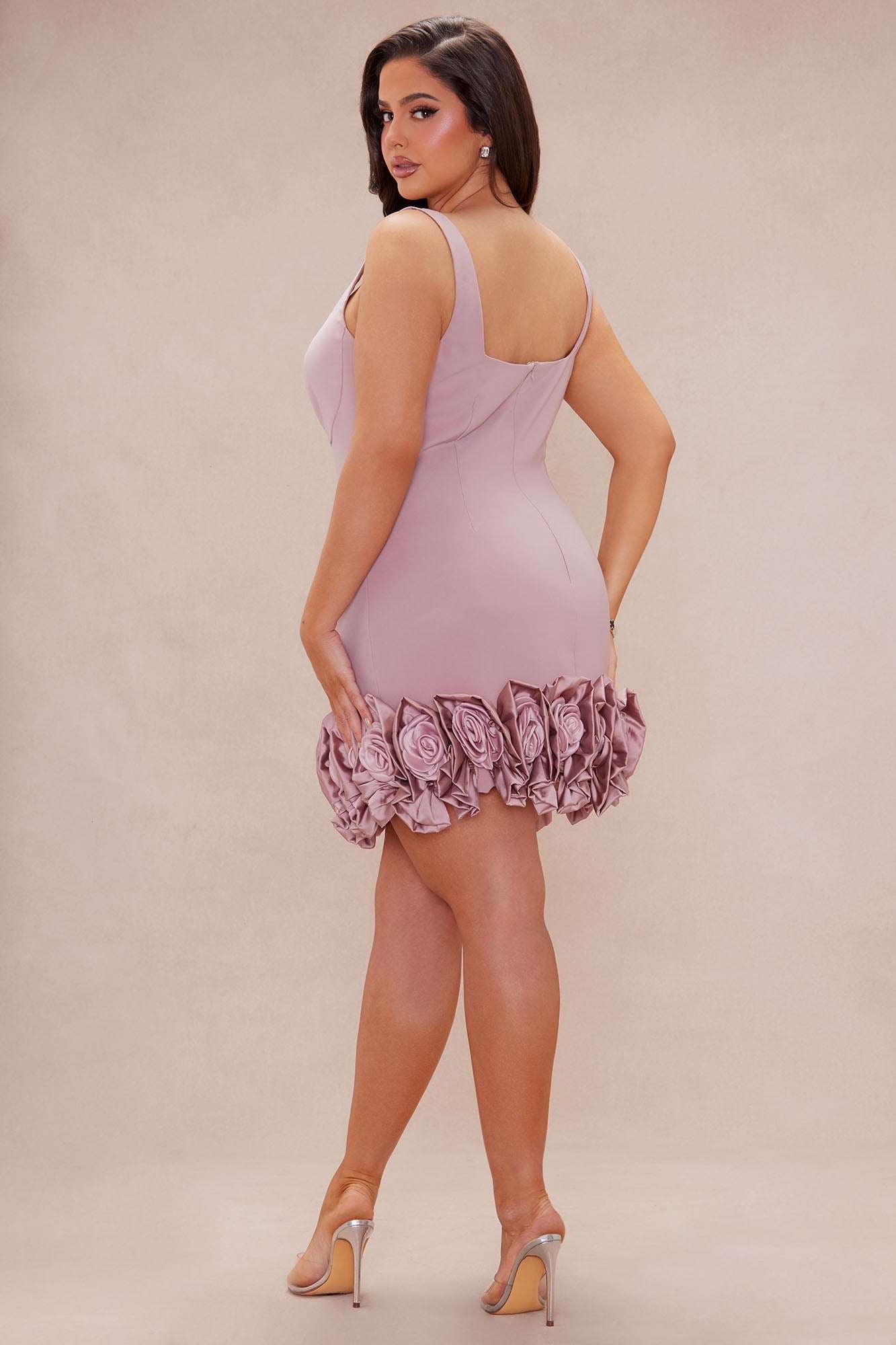 Woman wearing Sasha Rose Hem Mini Dress in rose color with floral hem detailing