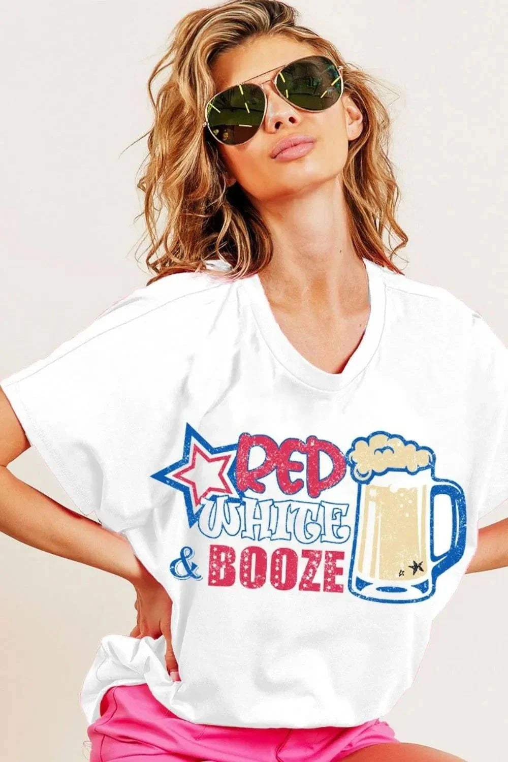 Woman wearing BiBi Red White and Booze Top white graphic jersey with festive print and sunglasses