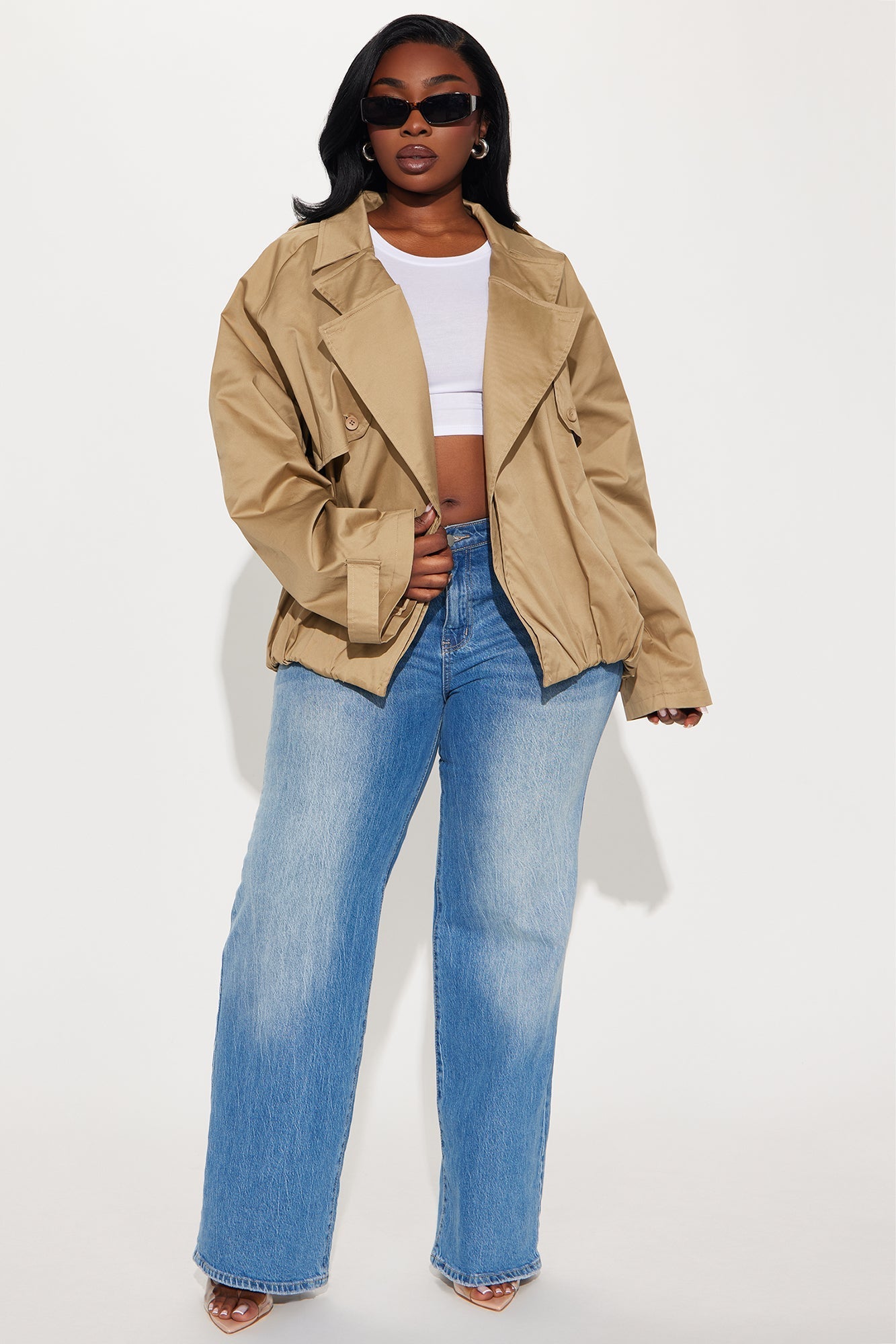 Woman wearing taupe Marie Cropped Bubble Trench with white crop top and blue jeans