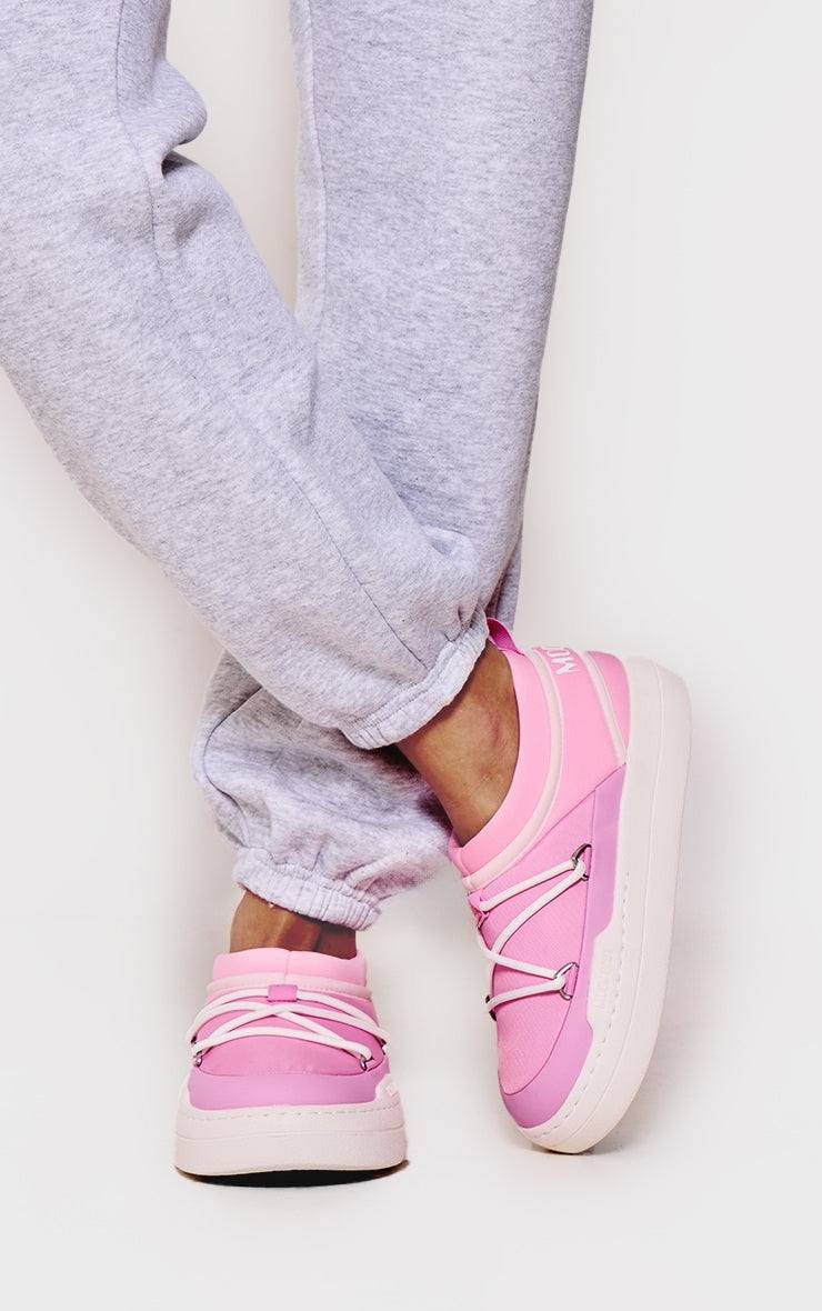 MOON BOOT Pink Park Icon slip-on pink sneakers with tubular laces and white sole, worn with grey joggers