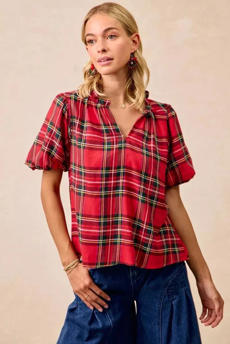 BiBi Christmas Plaid Short Sleeves Ruffled BlouseThis Christmas plaid short sleeves ruffled blouse is a festive and charming addition to your holiday wardrobe. The classic plaid pattern evokes a cheerful and cozy hChristmas plaid blouse