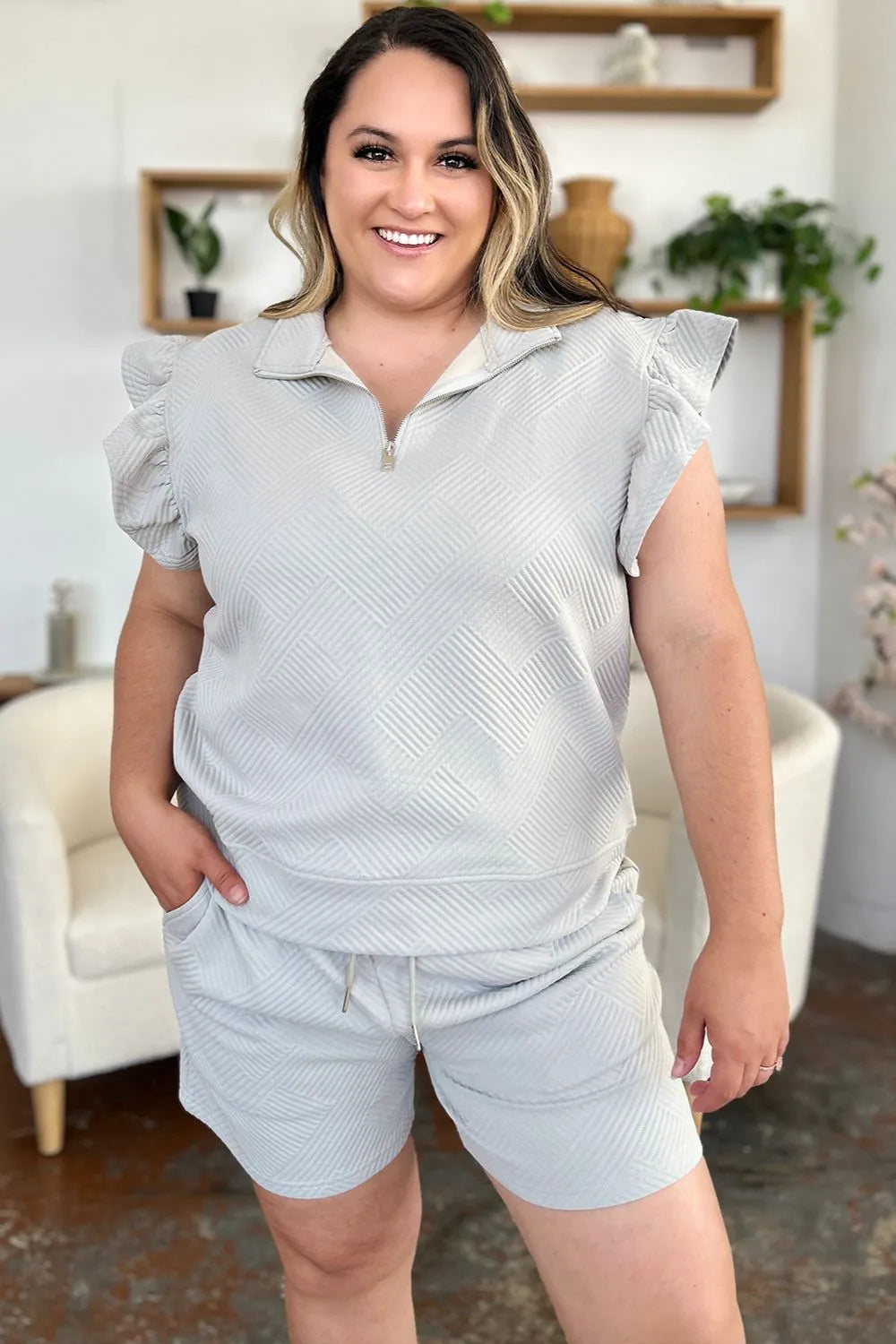 Plus size woman wearing Double Take Full Size texture flounce sleeve top and drawstring shorts set