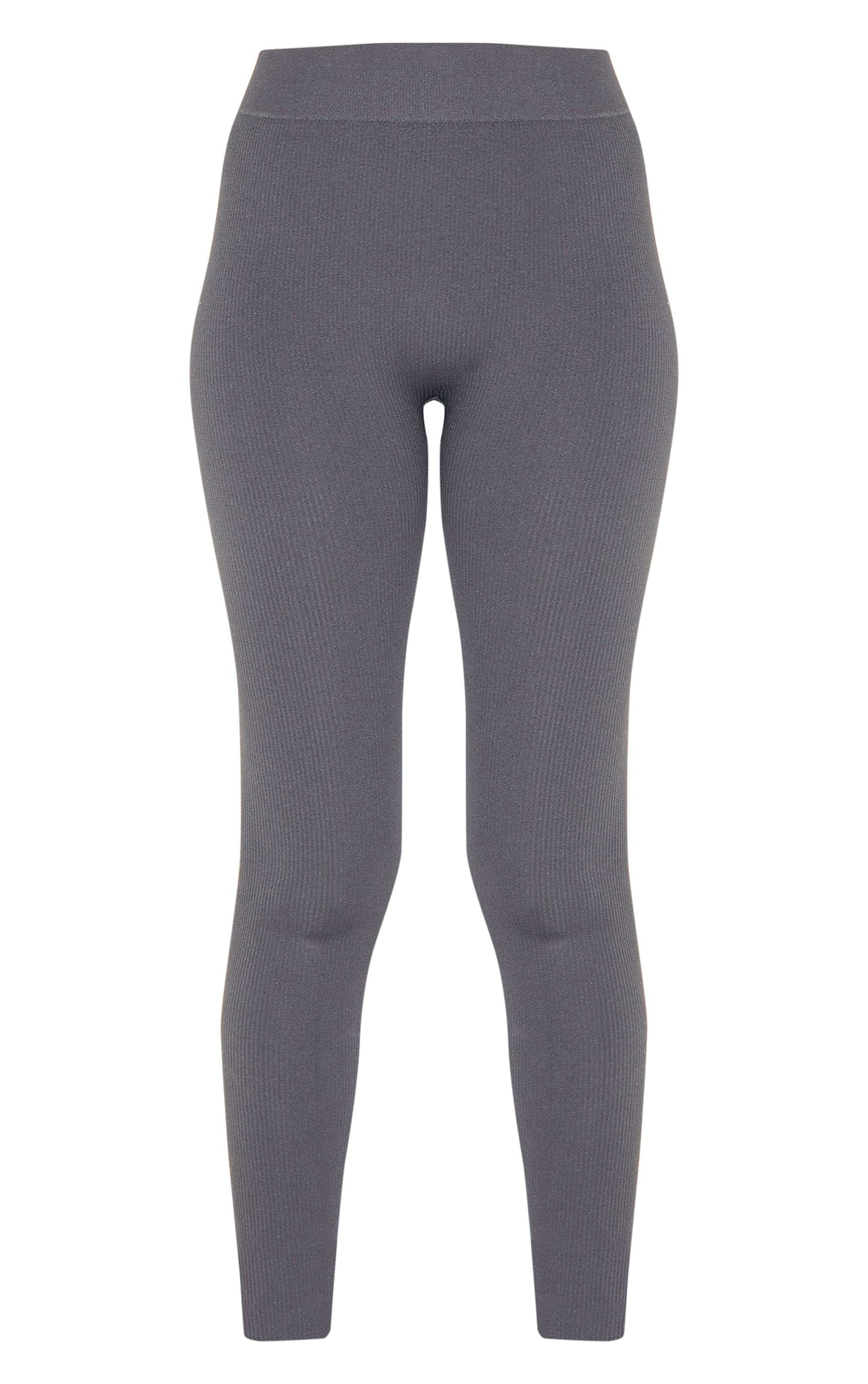 Black structured contour ribbed leggings with a sculpting knit design for a defined silhouette