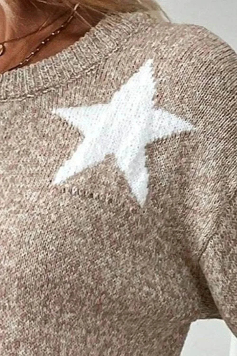 Close-up of beige Star Round Neck sweater with white star design on dropped shoulder, knitted fabric