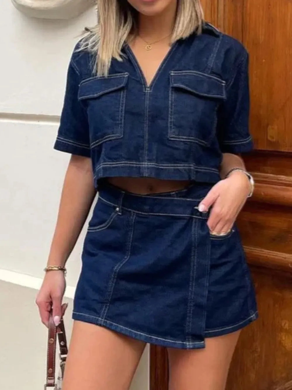 Woman wearing Johnny Collar short sleeve denim top and matching skort set with buttoned front and pockets