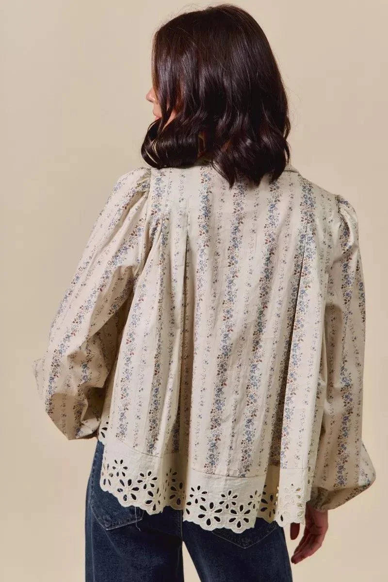 Back view of floral print lace button-down shirt with eyelet lace hem and puff sleeves