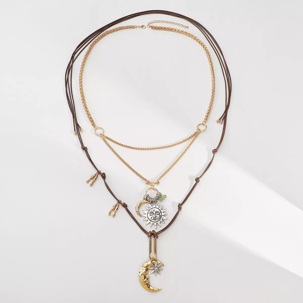 Moon & Sun Pendant Necklace with 18K gold-plated and silver-plated charms on layered chains