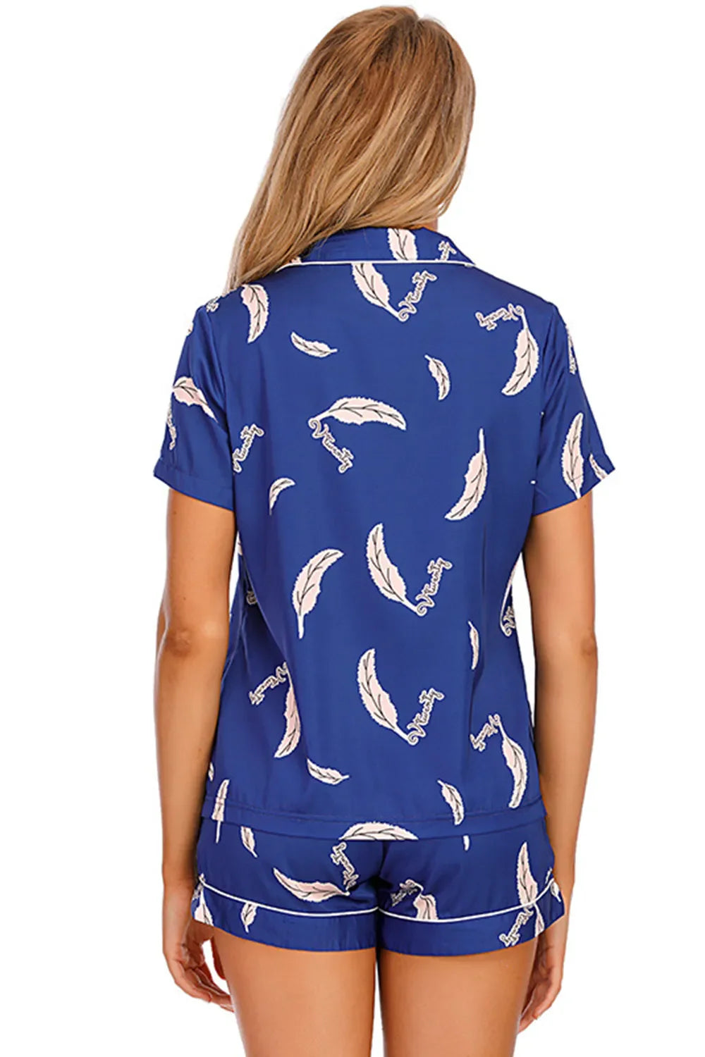 Woman wearing blue printed button up short sleeve top and shorts lounge set
