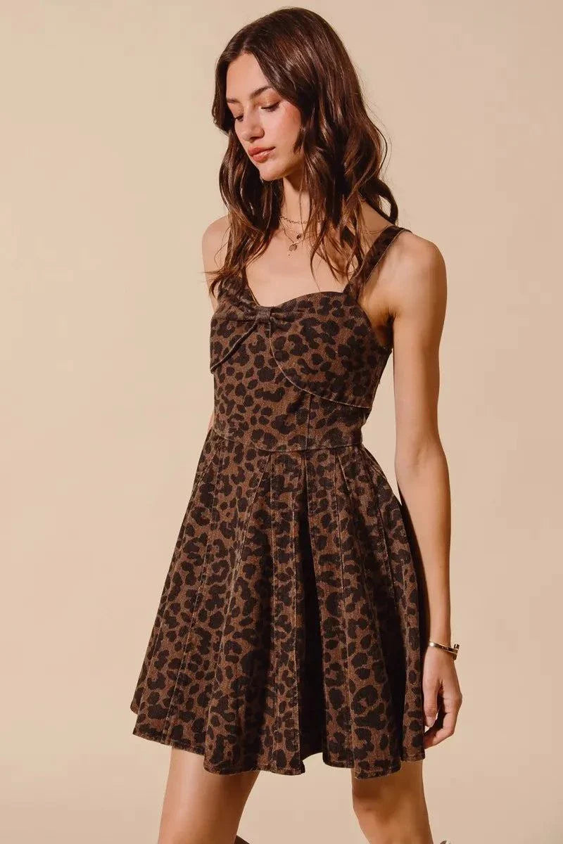 Woman wearing SO ME mineral washed leopard print flare cami dress against beige background