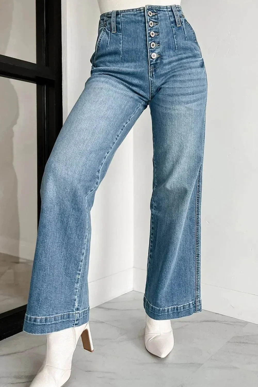 Button Fly High Waist Jeans in light blue denim with wide legs and white boots, styled for a modern look