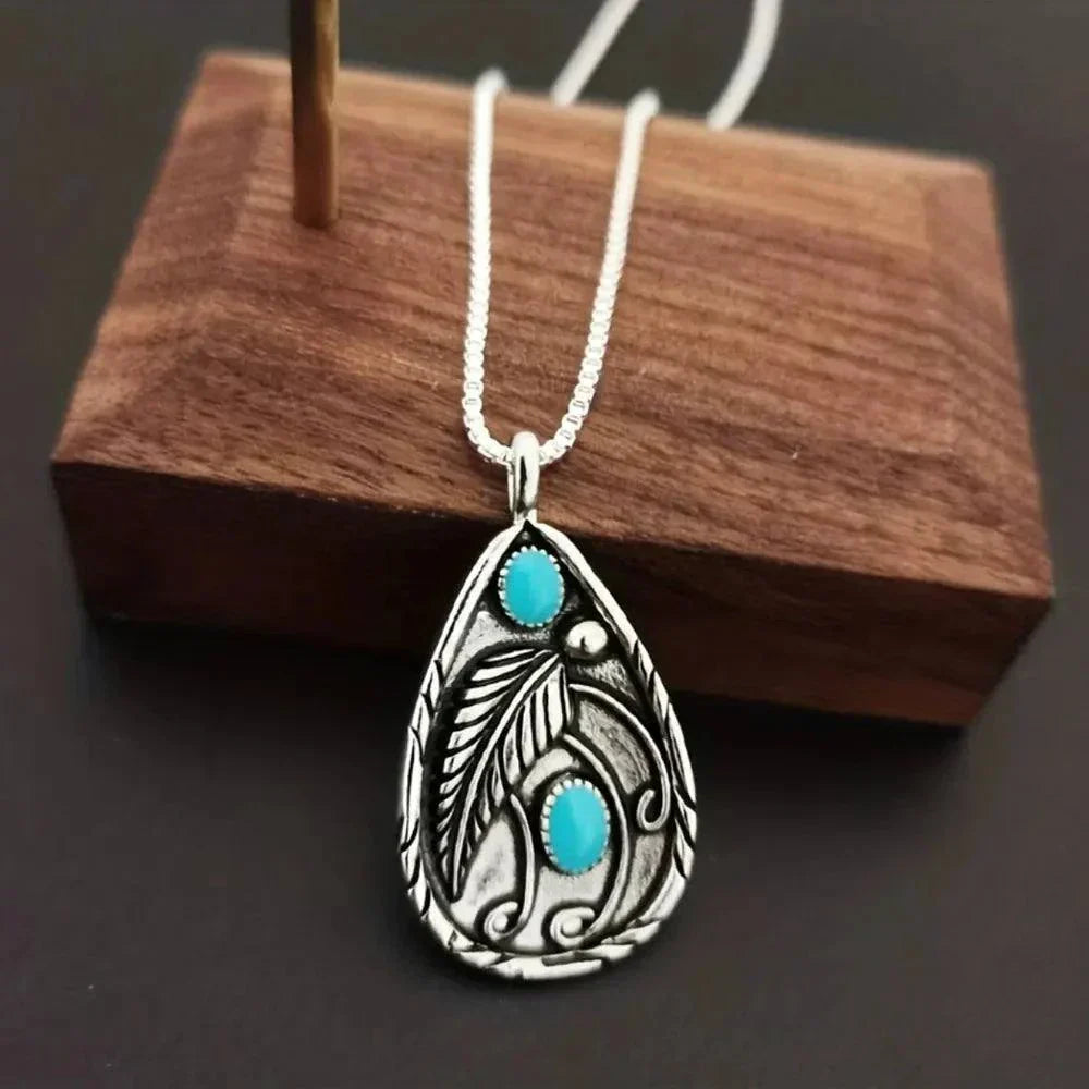 alloy necklace with turquoise teardrop pendant featuring intricate leaf design