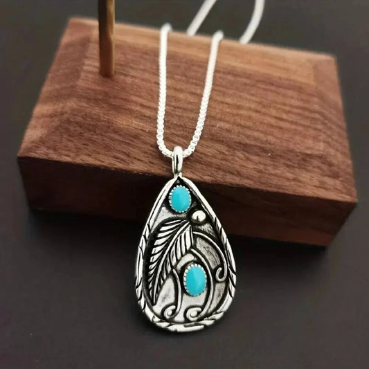 alloy necklace with turquoise teardrop pendant featuring intricate leaf design