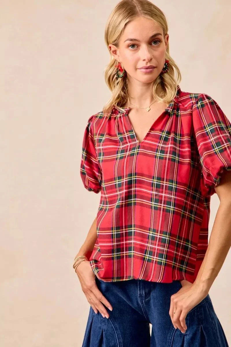 BiBi Christmas Plaid Short Sleeves Ruffled BlouseThis Christmas plaid short sleeves ruffled blouse is a festive and charming addition to your holiday wardrobe. The classic plaid pattern evokes a cheerful and cozy hChristmas plaid blouse