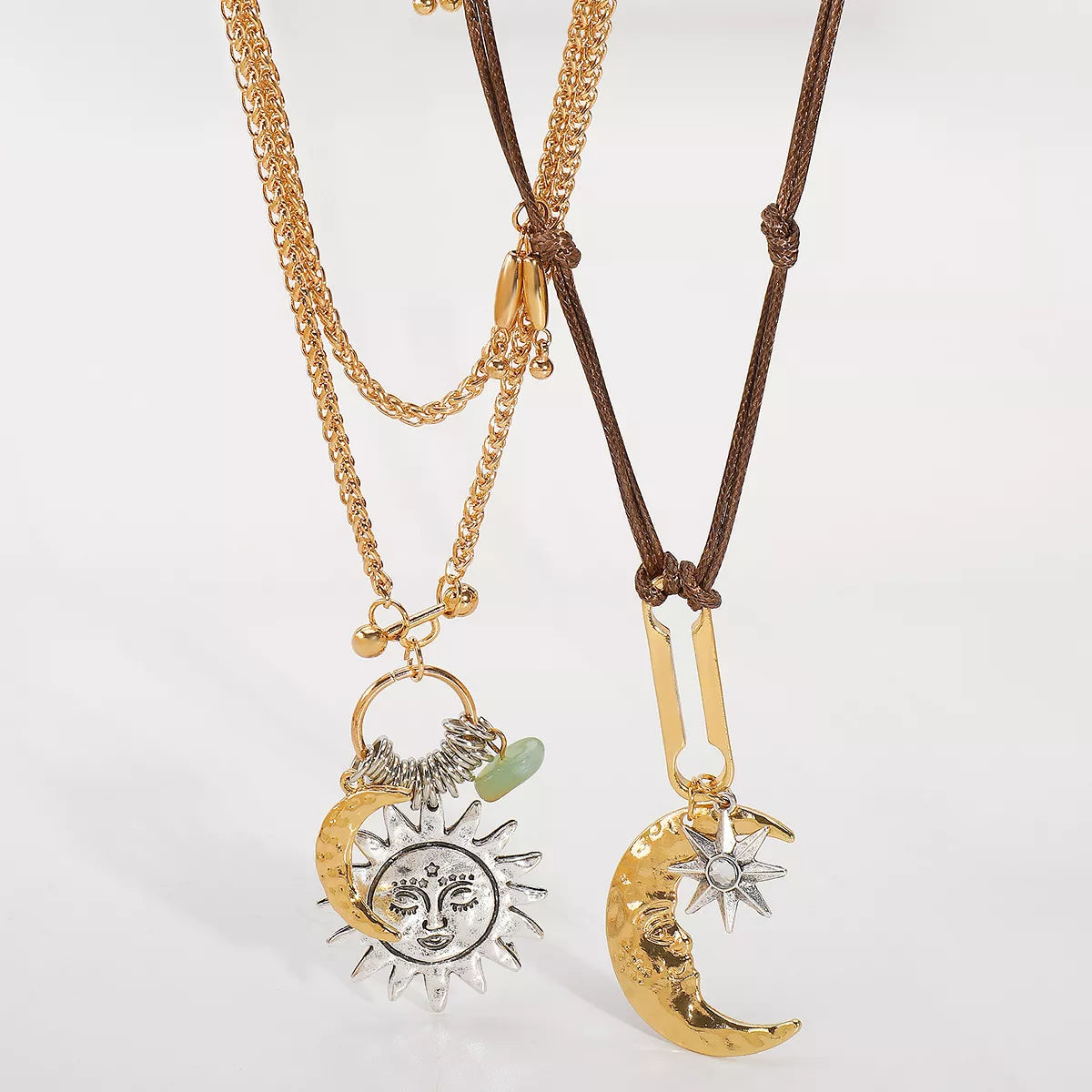 Two Moon & Sun Pendant necklaces with gold-plated and silver-plated details on gold chain and brown leather cord