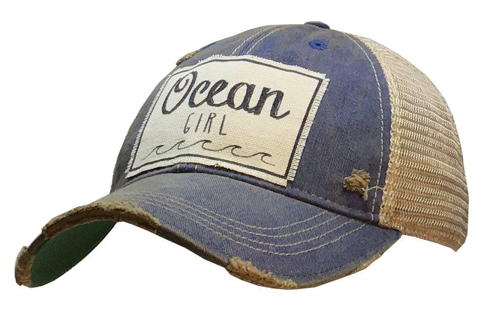 Ocean Girl trucker cap for women with distressed blue front, ocean graphic, and beige mesh back