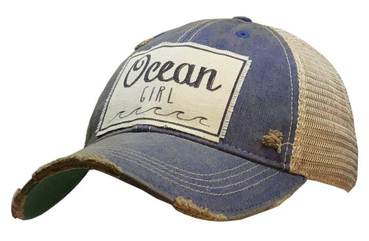 Ocean Girl trucker cap for women with distressed blue front, ocean graphic, and beige mesh back