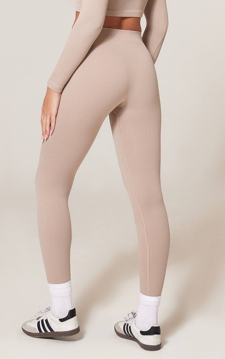 Beige ribbed structured contour leggings worn with white socks and sneakers