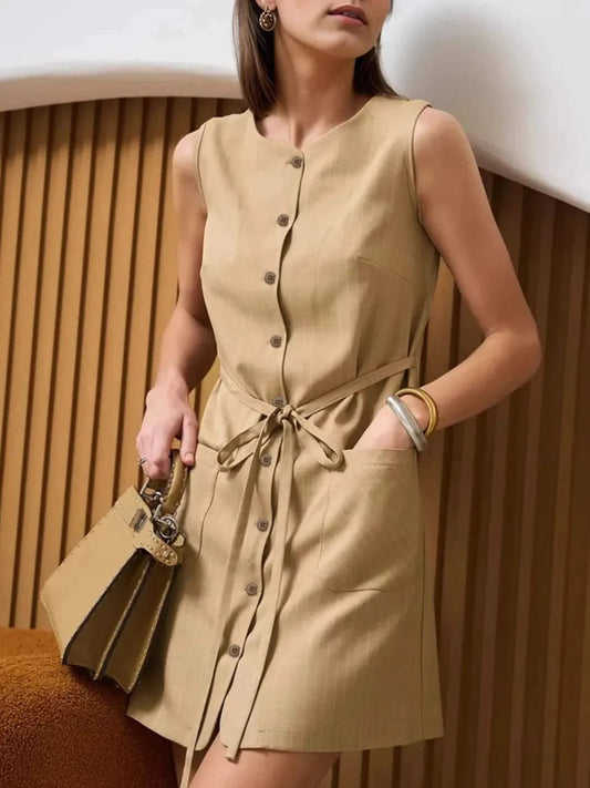 Button-front sleeveless beige mini dress with tie waist and buttons, stylish summer outfit