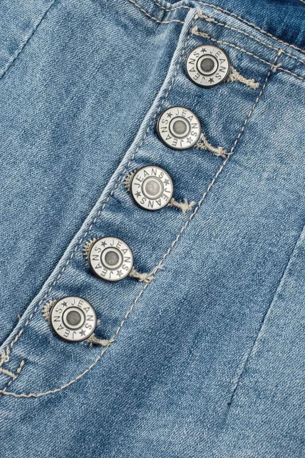 Close-up of button fly closure on high waist blue denim jeans