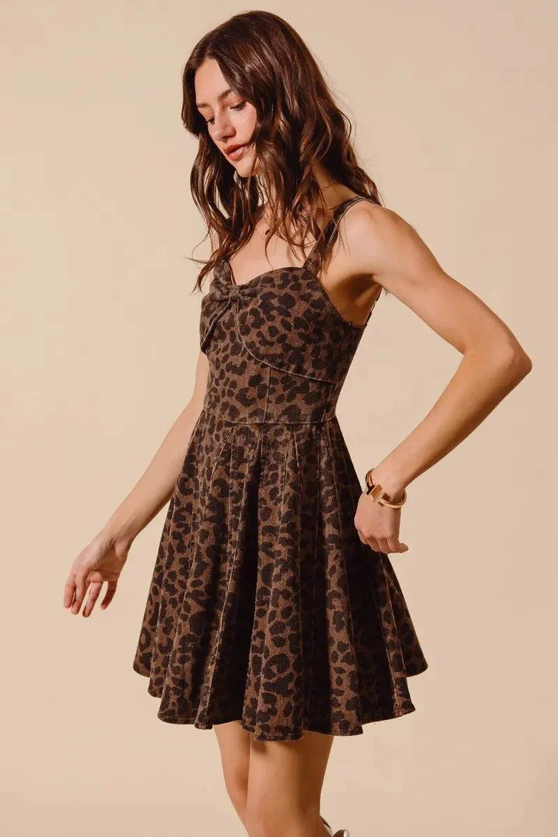 Woman wearing SO ME mineral washed leopard print flare cami dress with adjustable straps on beige background