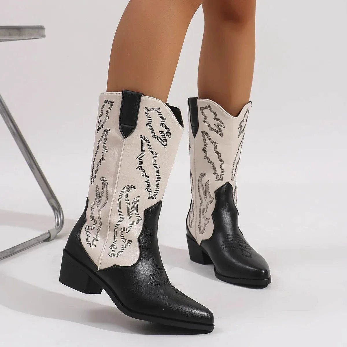Point toe block heels boots in black and white PU leather with mid heel and decorative stitching