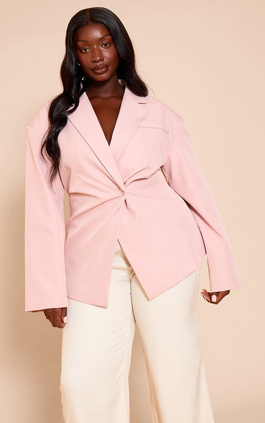 Plus pale pink tailored cinched waist blazer on model with wide leg trousers