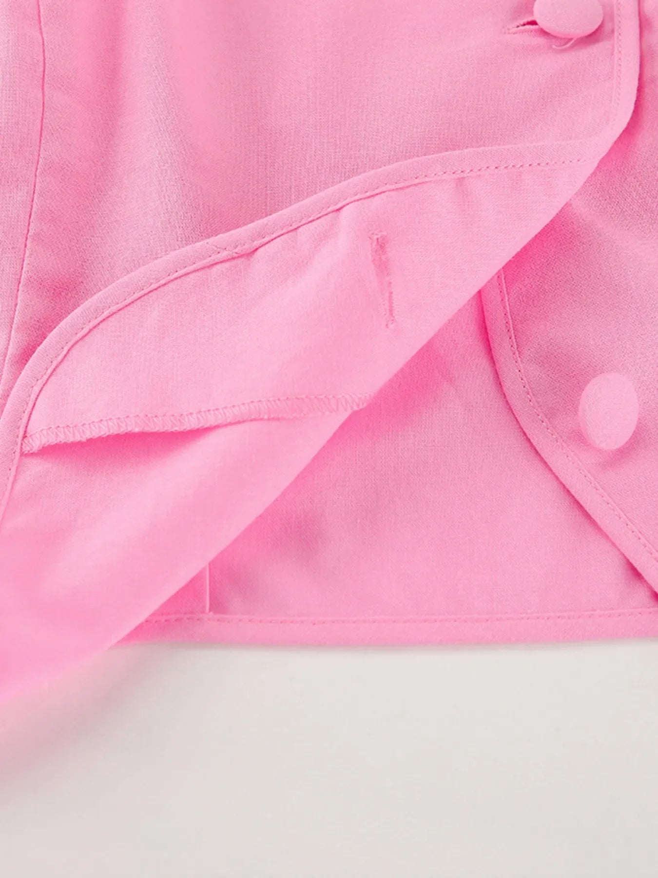 Pink buttoned short sleeve top and skirt set made of 100% cotton with no stretch.