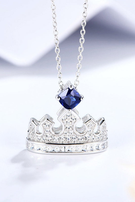 Minimalist crown-shaped pendant necklace with lab-grown sapphire and zircon in platinum-plated 925 sterling silver.