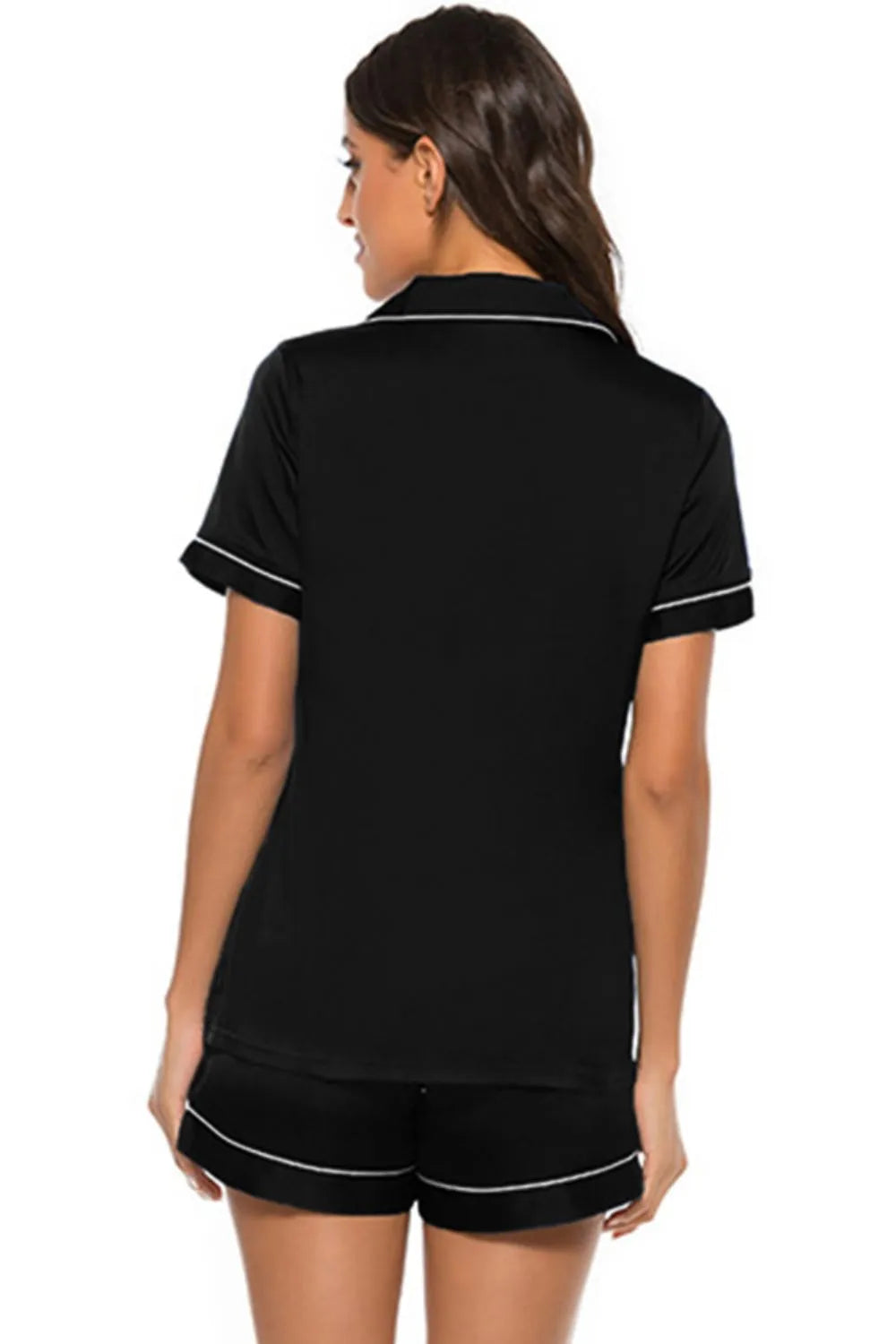 Back view of black printed button up short sleeve top and shorts lounge set with white trim