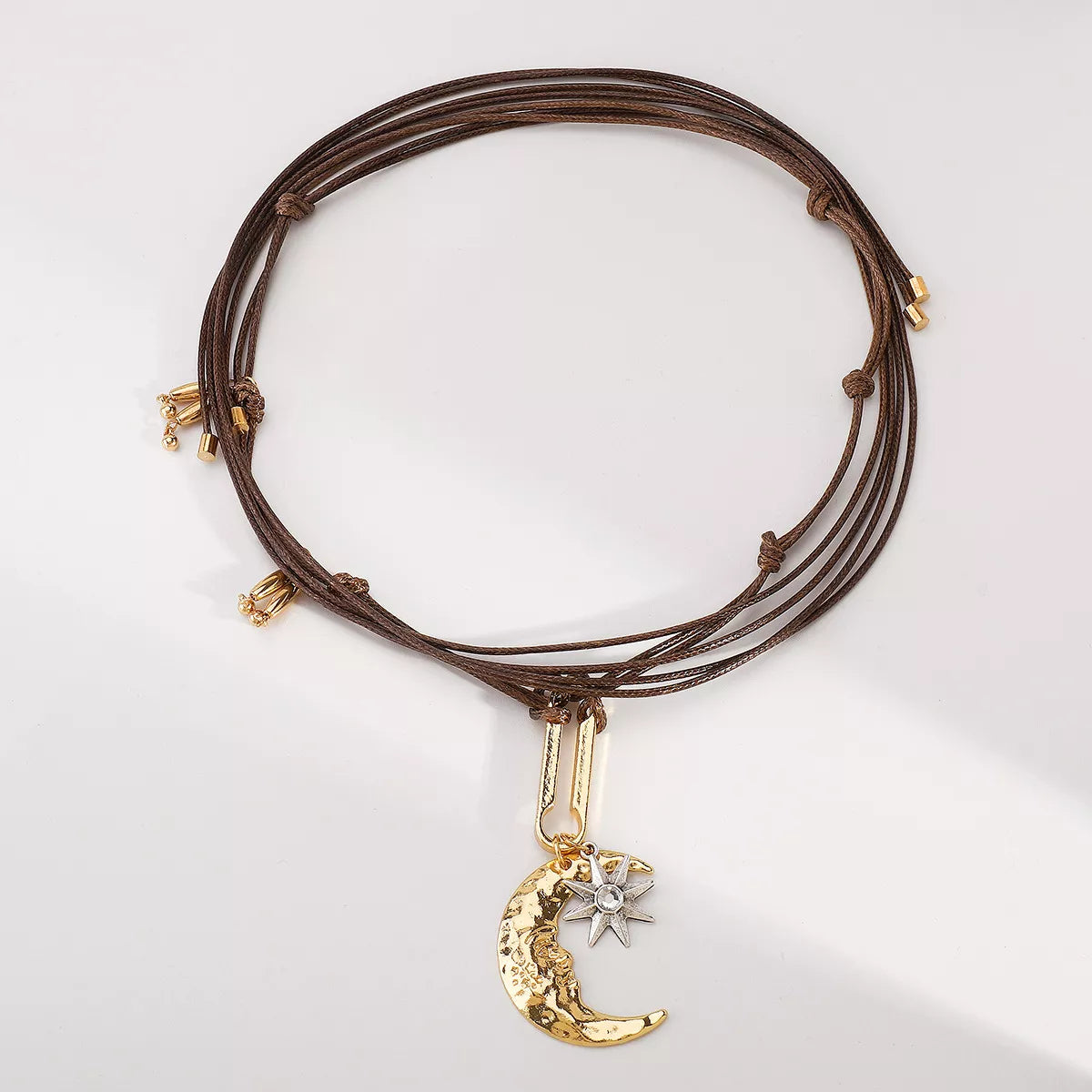 Moon & Sun Pendant Necklace with 18K gold-plated crescent moon and silver-plated sun on adjustable brown cord chain