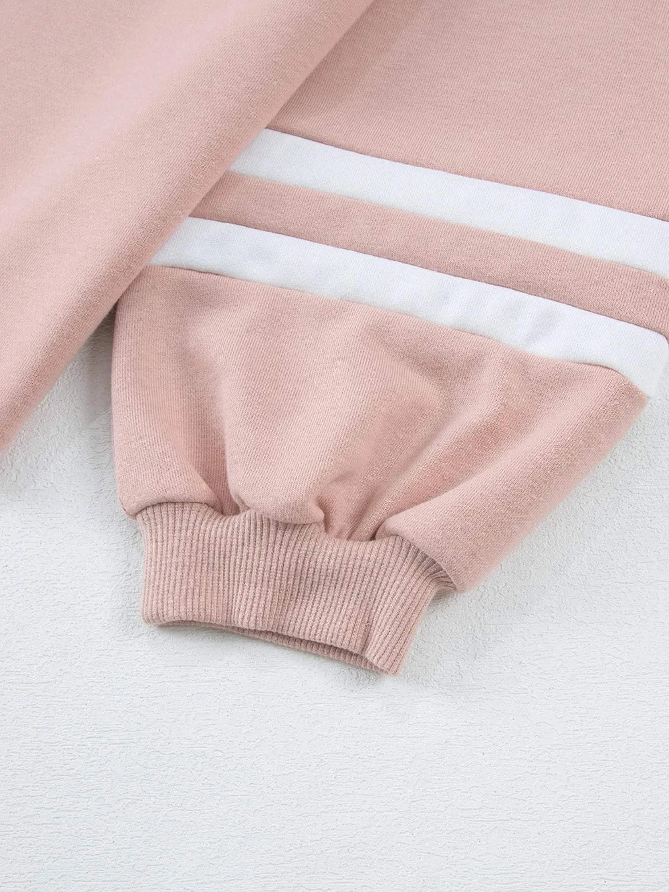 Close-up of pink Contrast Trim Round Neck Top sleeve with white stripes and ribbed cuff