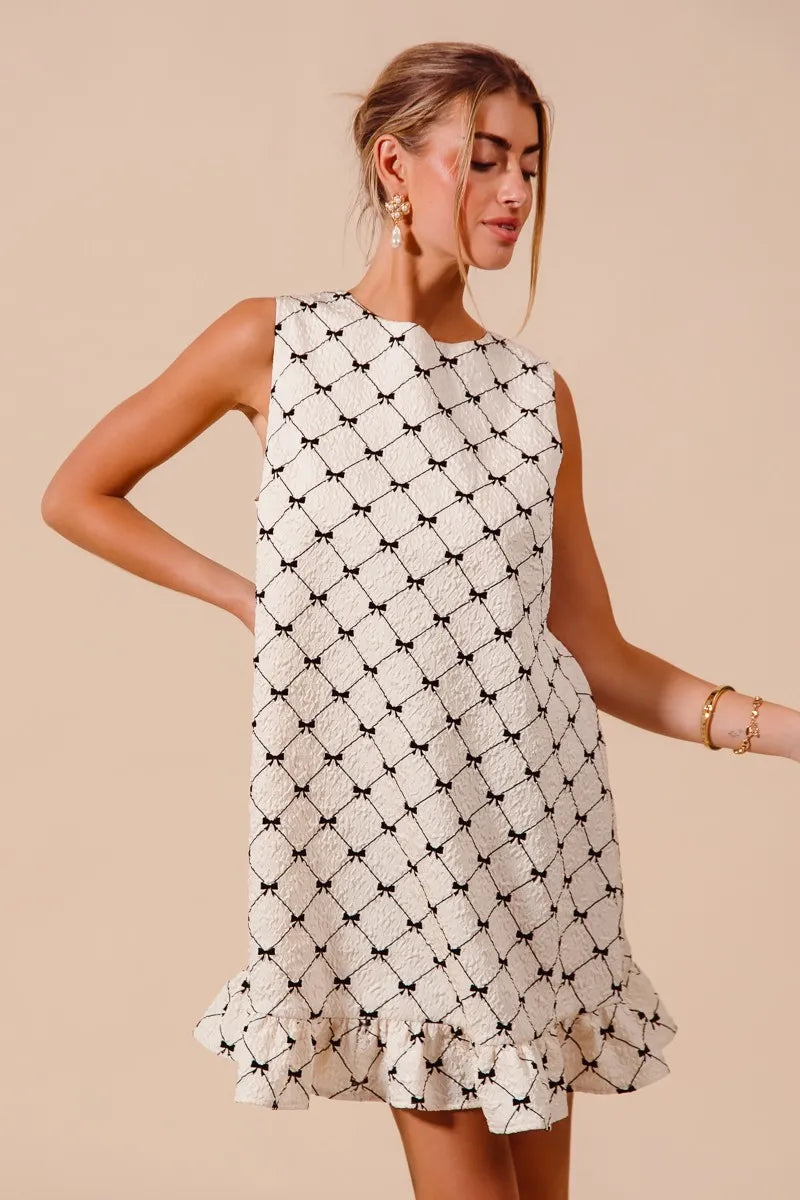 SO ME Texture Bow sleeveless mini dress with black and white bow print and ruffle hem
