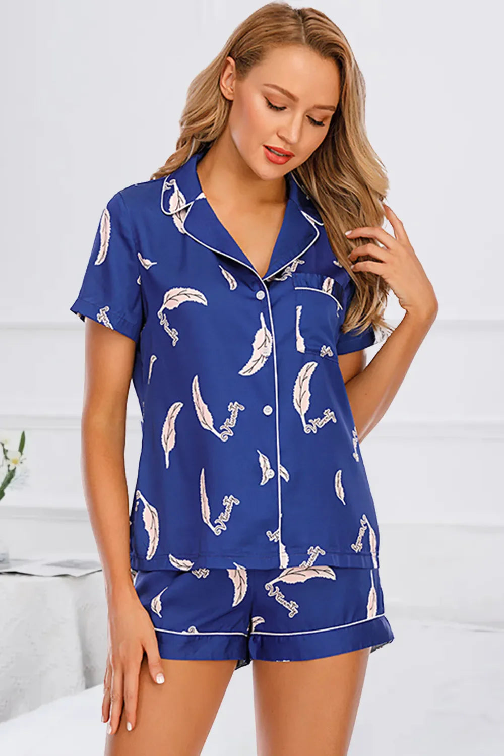 woman wearing blue printed button up short sleeve top and shorts lounge set