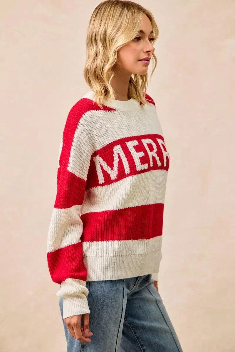 Woman wearing oversized BiBi Christmas Merry Lettering Sweater with red and cream horizontal stripes and bold "MERRY" text.