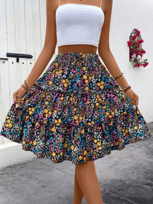 woman wearing floral print midi skirt and white crop top standing outdoors