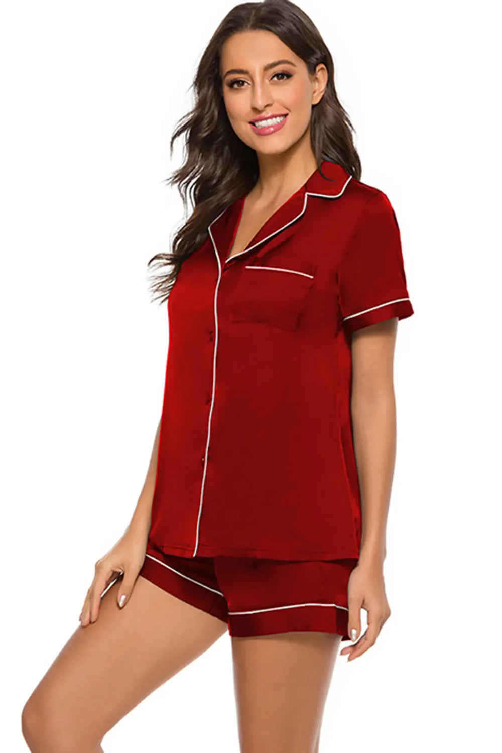 woman wearing red printed button up short sleeve top and shorts lounge set with white piping detail