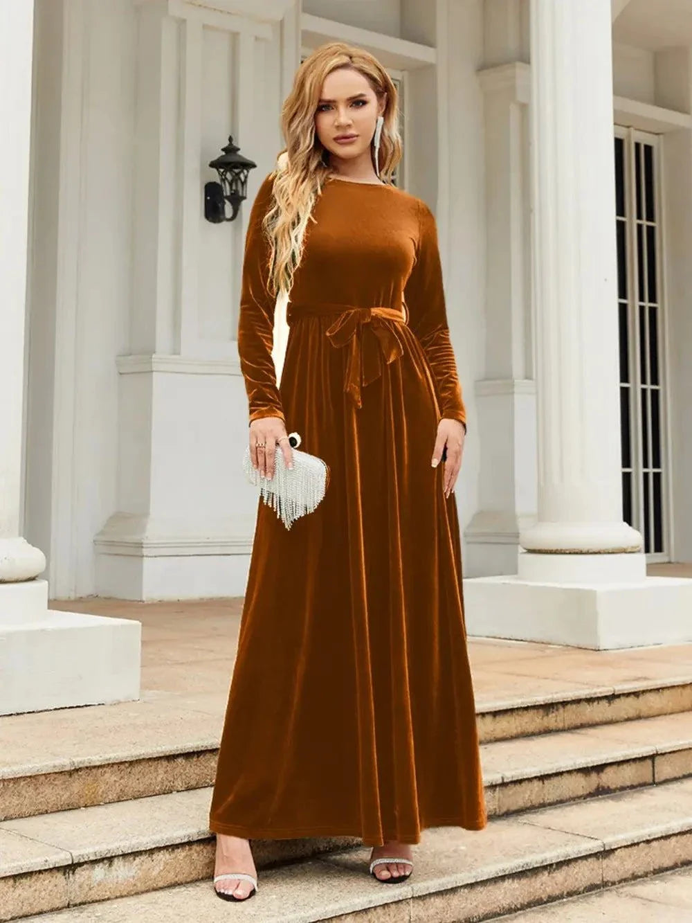 Woman wearing brown tie front round neck long sleeve maxi dress standing outdoors