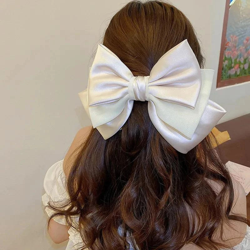 White bow cloth hair clip on brunette hair accessory