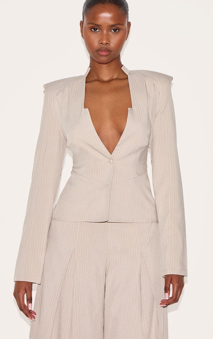 Beige pinstripe tailored jumpsuit with shirt neckline and long sleeves for evening wear