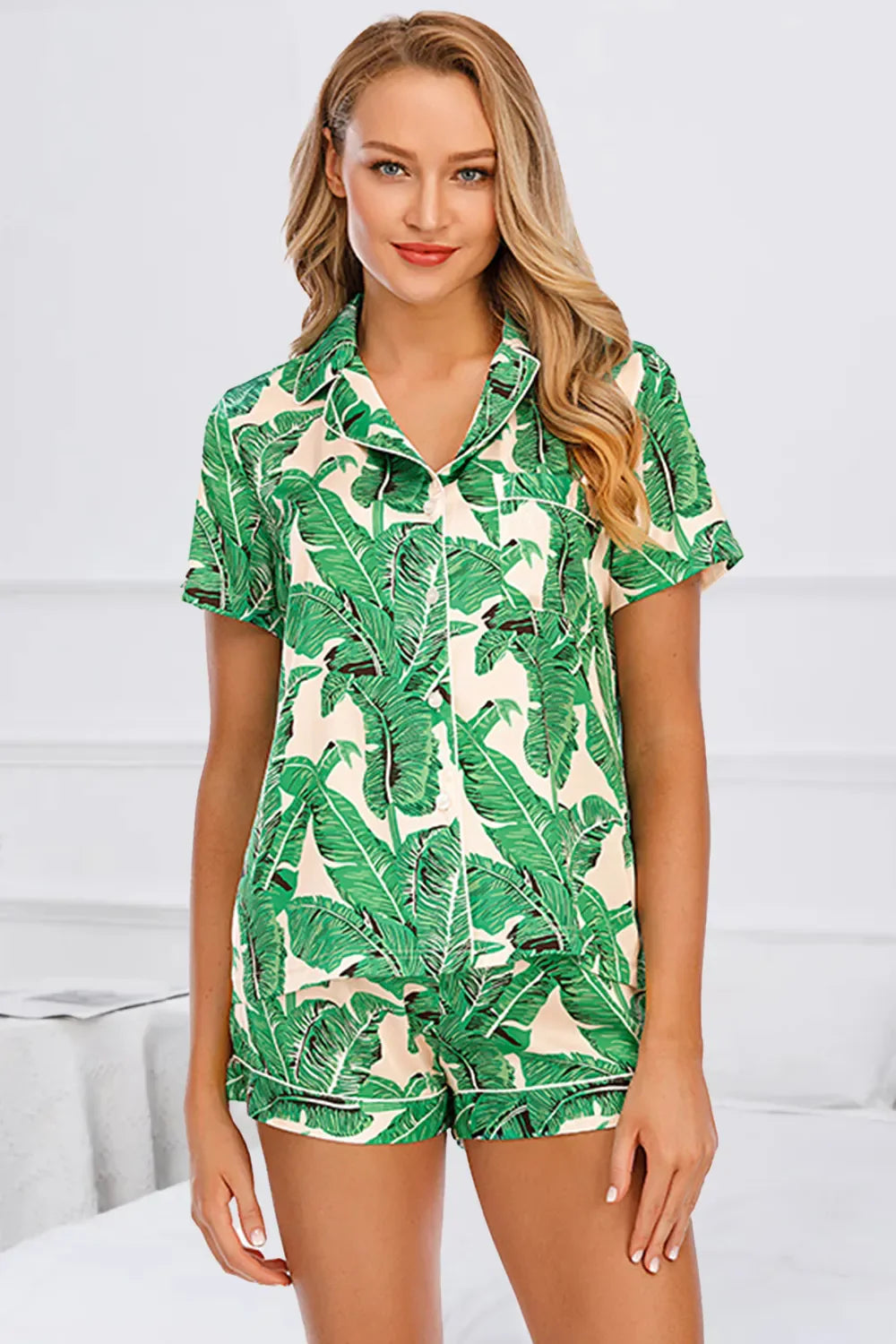 Printed button up short sleeve top and shorts lounge set with green leaf print on model