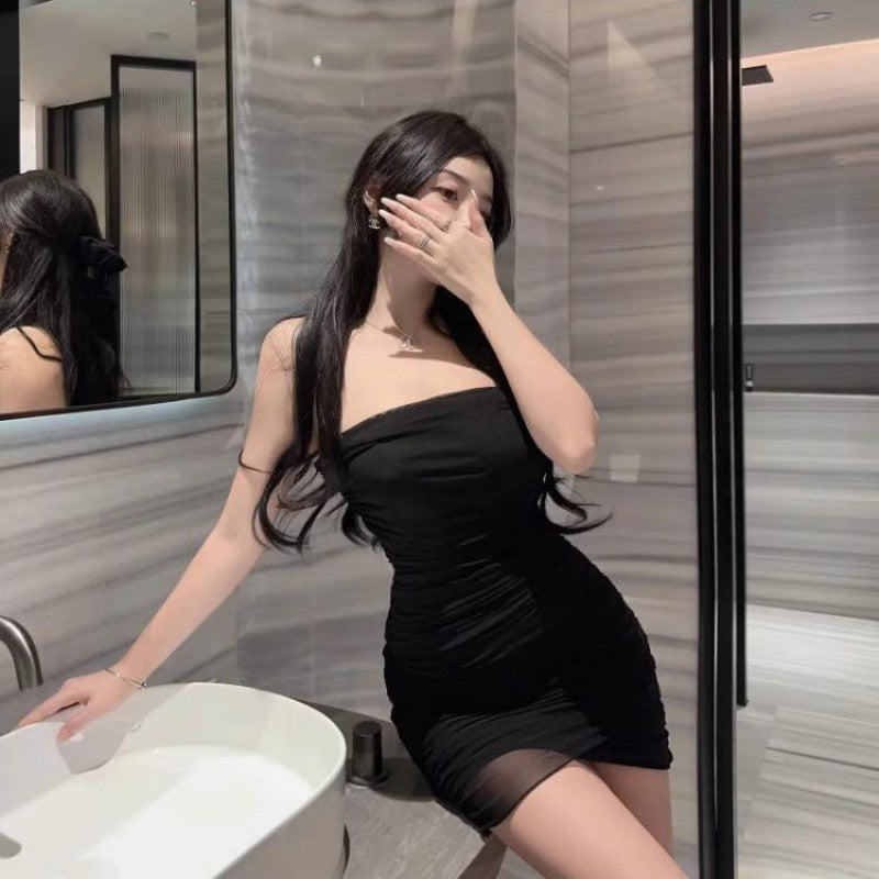 Woman wearing black summer mesh tube top skirt posing in modern bathroom